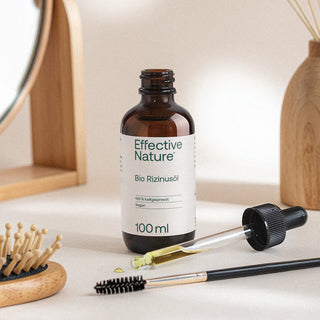 Effective Nature Bio Rizinusöl 100ml Braunglasflasche mit Pipette, Haarbürste und Wimpernbürste auf hellem Untergrund