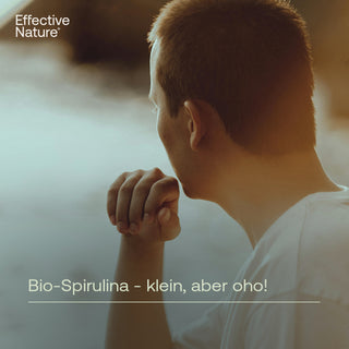 Junger Mann von hinten, Hände gefaltet, nachdenklich – Effective Nature Bio-Spirulina Werbebild mit Text